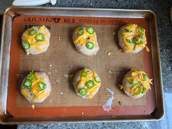 sourdough bagels topped with cheddar cheese and jalapenos