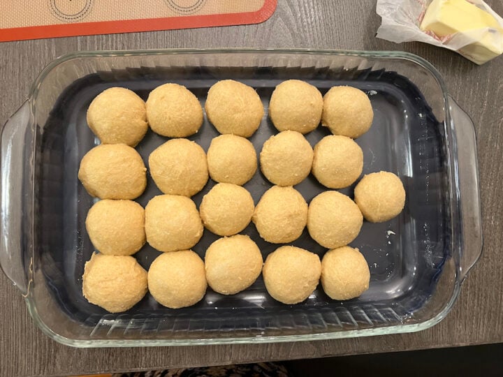 sourdough dinner rolls dough in a dish getting ready to rise