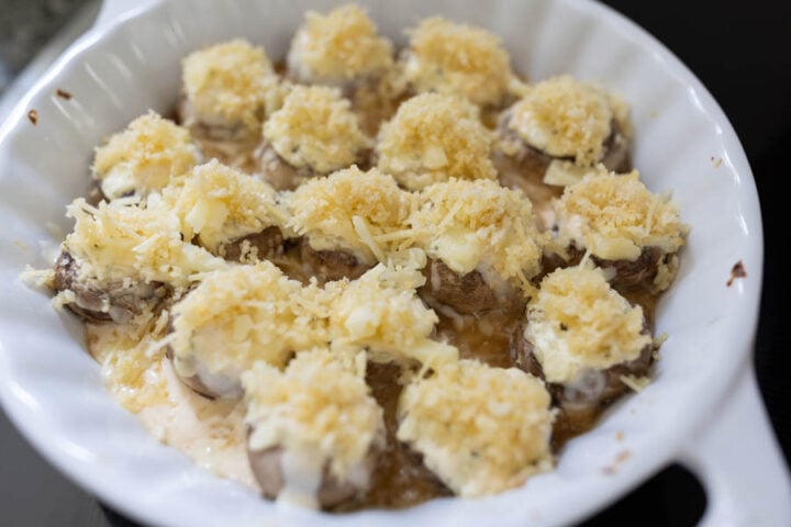 Assembling stuffed mushrooms before they broil in the oven