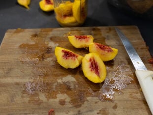 peeling, pitting, and slicing peaches for the jars