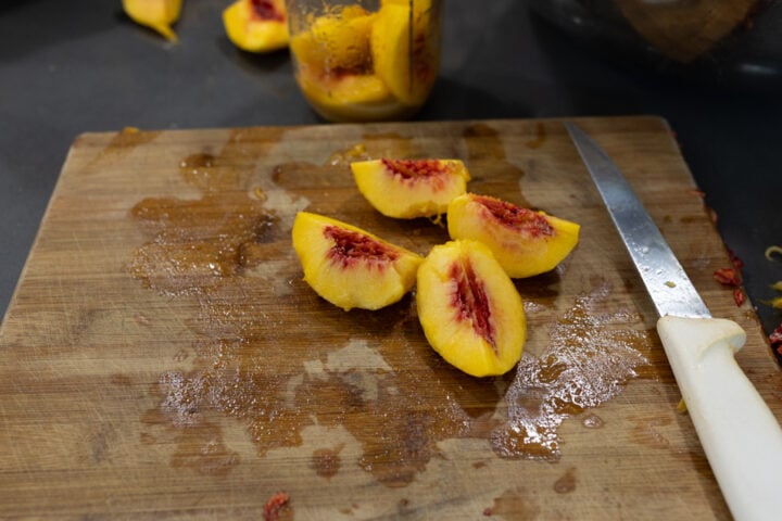 peeling, pitting, and slicing peaches for the jars