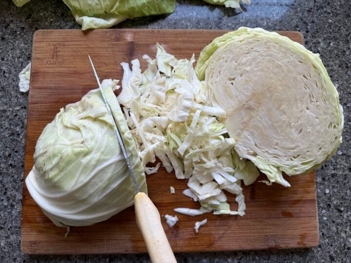 chopping the cabbage for sauerkraut by hand with a knife