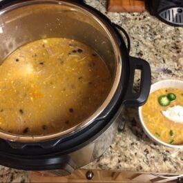 instant pot white chicken chili in a bowl and an instant pot.