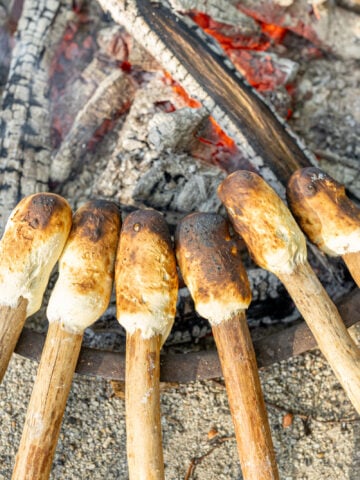 image of homemade Woof em sticks by the camp fire