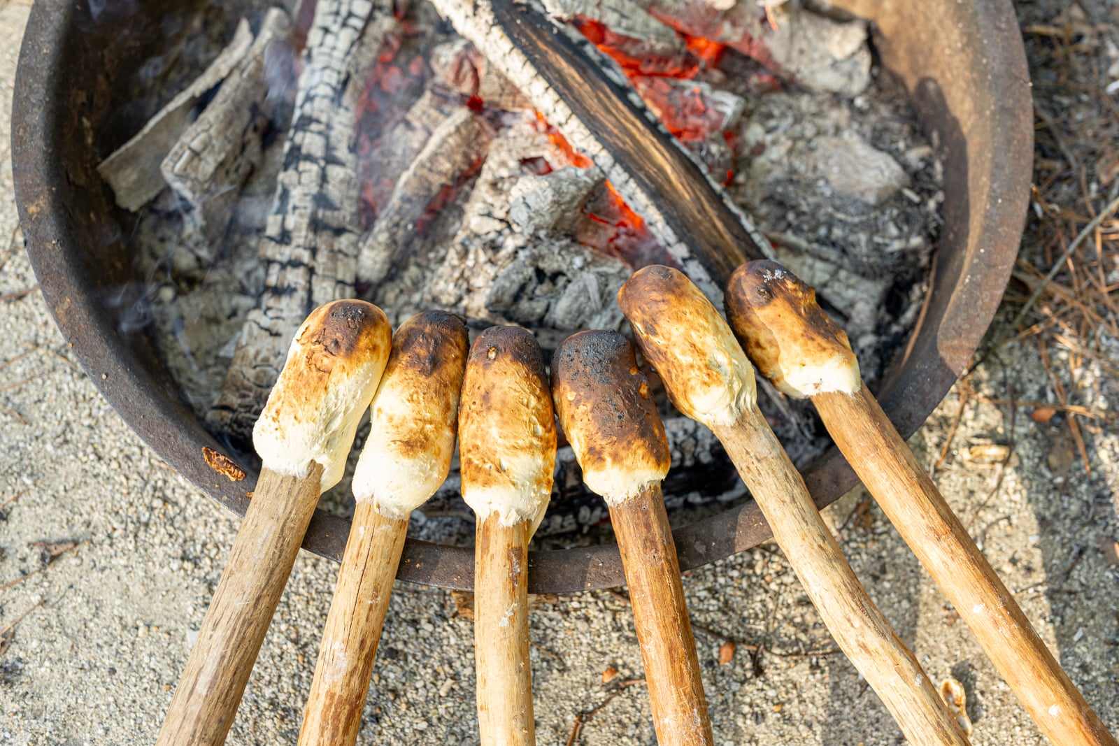 image of homemade Woof em sticks by the camp fire