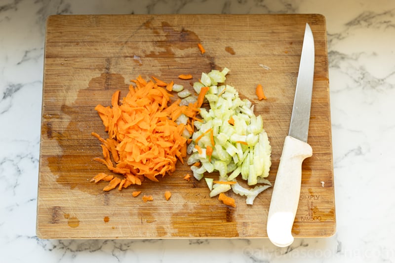image of meal prep for freezer lasagnas (chopped celery and a grated carrot)