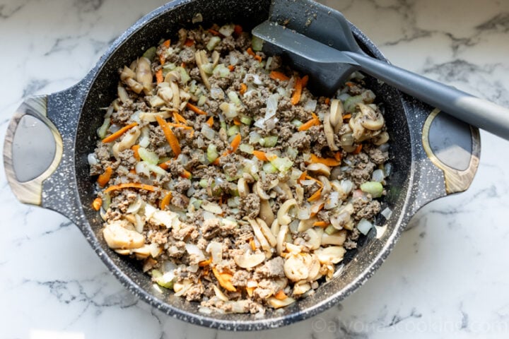 image of sautéed vegetables, ground beef, and seasonings for lasagna meat sauce