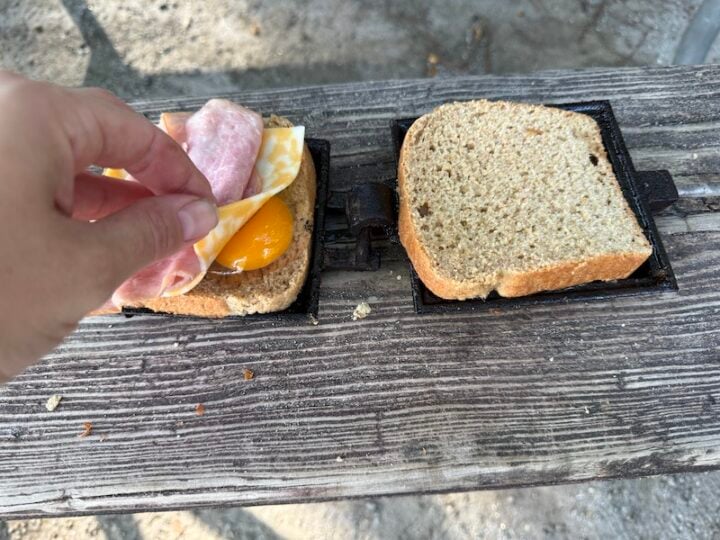 image of breakfast mountain pie sandwich (whole wheat bread, egg, ham, and cheese)