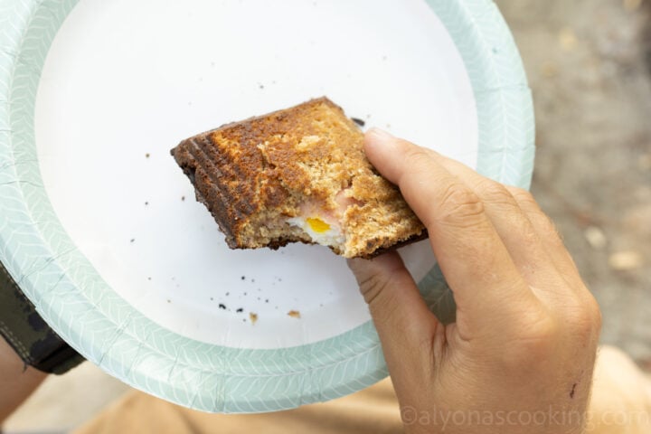 image of hot mountain pie sandwich on a paper plate outdoors (camping)