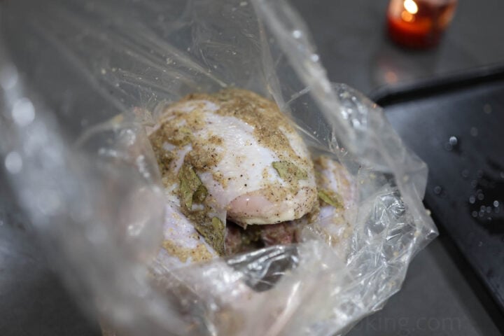 image of a Thanksgiving turkey rubbed with seasonings and an onion slurry
