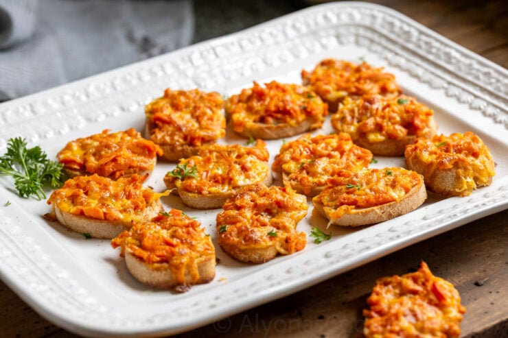 image of cheesy hot carrot sandwiches on a white platter
