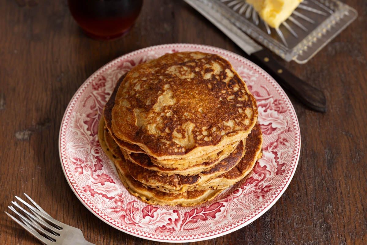 whole grain einkorn pancakes on a red vintage plate