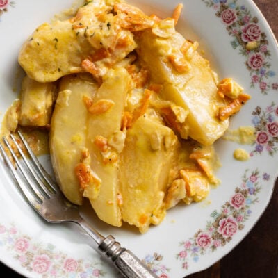 image of creamy potato wedges smothered in a heavy cream sauce with onions and carrots