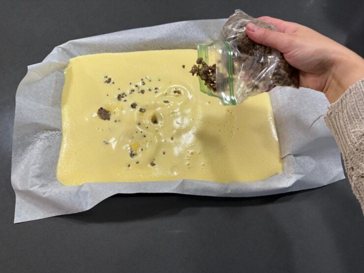 image of sheet pan eggs sprinkled with breakfast sausage