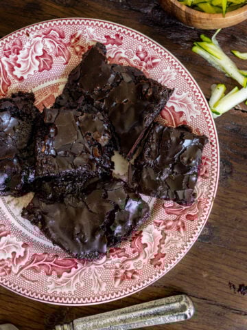 image of rich and fudgy zucchini brownies Made with fresh milled flour on a vintage red plate