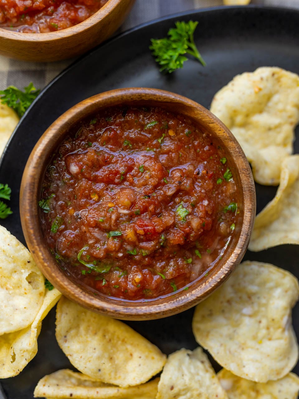 image of homemade salsa made from canned diced tomatoes served on a black plate with tortilla chips