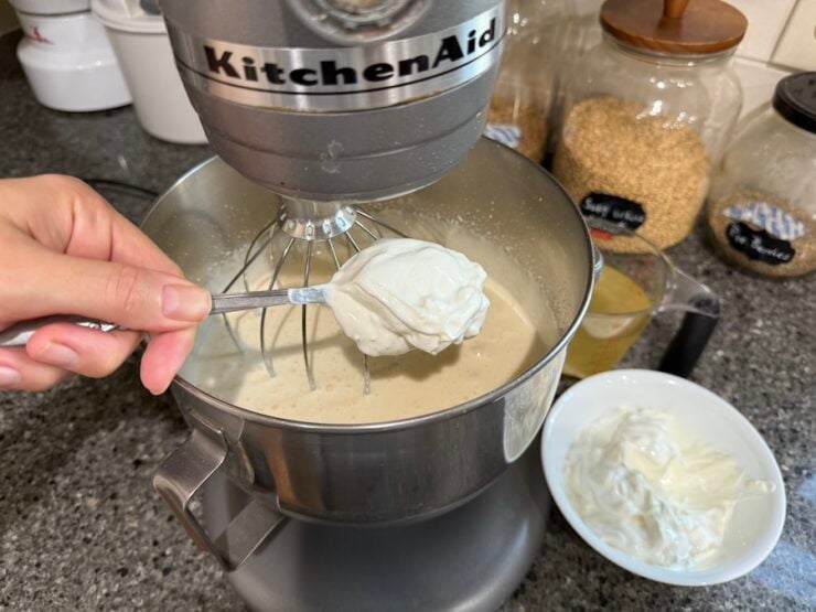 image of sour cream being added to a sponge cake for tiramisu