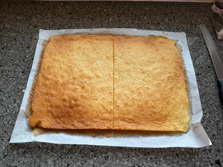 a sheet pan tiramisu cake cut in half to assemble for layering