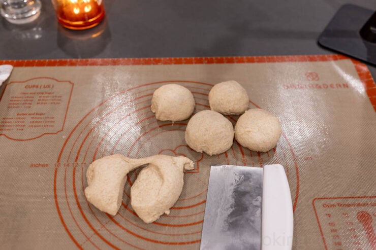 image of sourdough whole wheat pitas shaped into balls, before rolling out into circles.