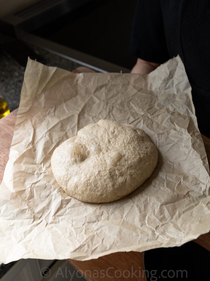 image of a homemade, soft, sourdough pizza crust with fresh milled flour (made from whole grain wheat berries)