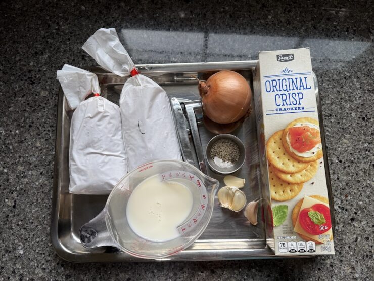 image of all the ingredients for Chicken Kotleti (ground chicken, onion, garlic, salt, pepper, milk, and buttery crackers).