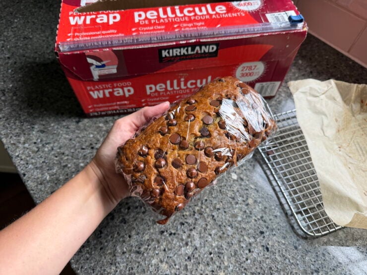 how to freeze chocolate chip banana bread (image of chocolate chip banana bread doubled wrapped in plastic wrap for storing in the freezer).