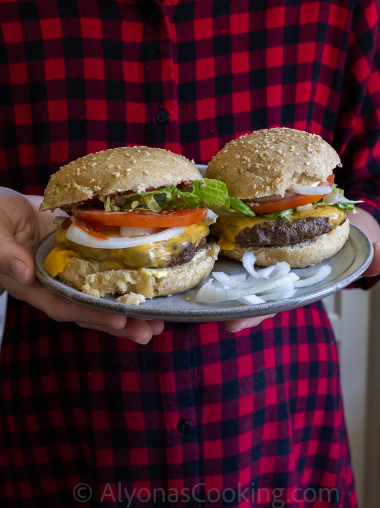 image of two oven baked burgers assembled and arranged on a plate