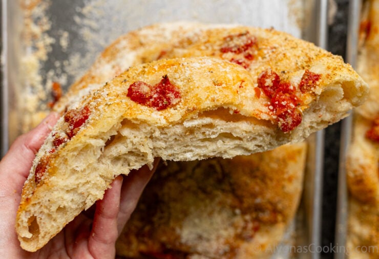 image of halved tomato focaccia bread, ready for roasted tomato and pesto focaccia sandwiches