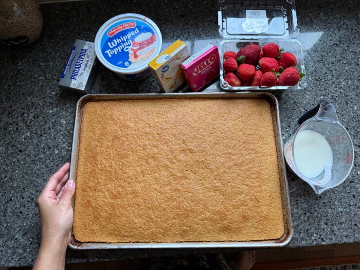 all the ingredients for strawberry sheet cake (homemade yellow cake), fresh strawberries, raspberry jello, vanilla pudding mix, milk, Whipped topping, and cream cheese.