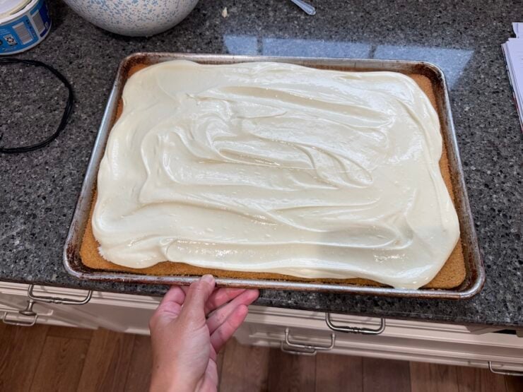 luscious cream cheese frosting spread over a yellow sheet cake made with fresh milled flour