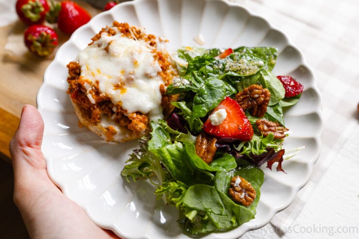 image of serving a strawberry spinach salad with an English muffin pizza served on a plate