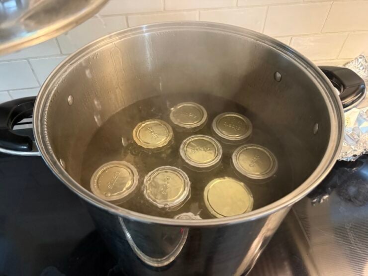 image of pickled jalapeños in a large pot being water bathed