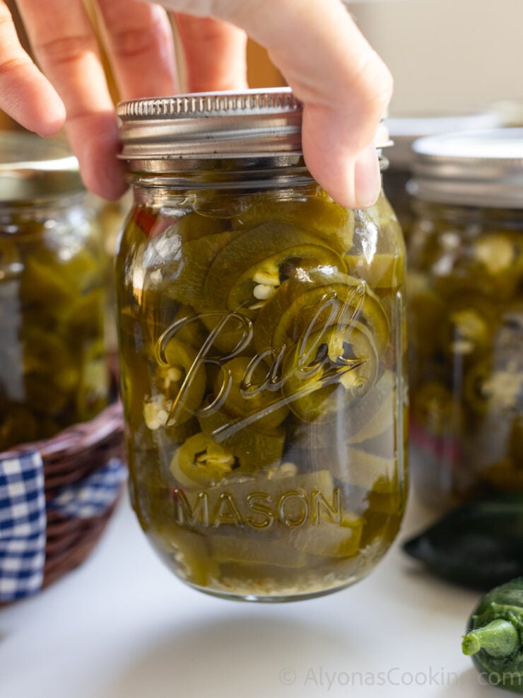 zoomed in jar of home canned pickled jalapeños